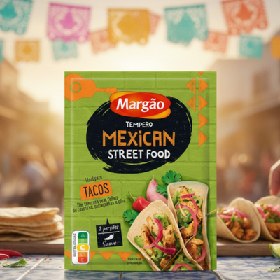 Margão Mexican Street Food seasoning packet with tacos on a table in a street setting.