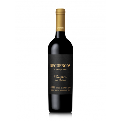 Red wine bottle with gold foil cap and black label on a white background