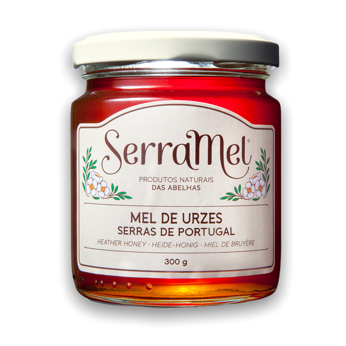 A jar of Heather Honey labeled as 'Mel de Urzeis' from Serramel, with a dark amber color honey visible inside the transparent jar.